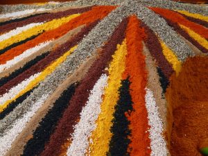 Striped display of colorful spices arranged in a market.